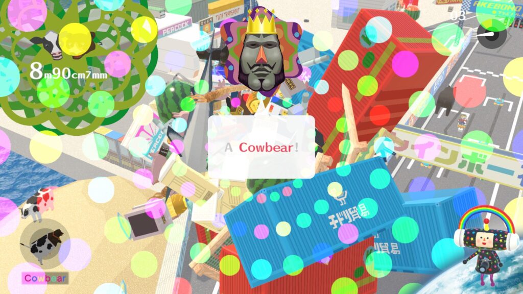 A screenshot of We Love Katamari of finishing the cow-bear stage by rolling up the Cowbear. The king is surprised saying "A Cowbear!"