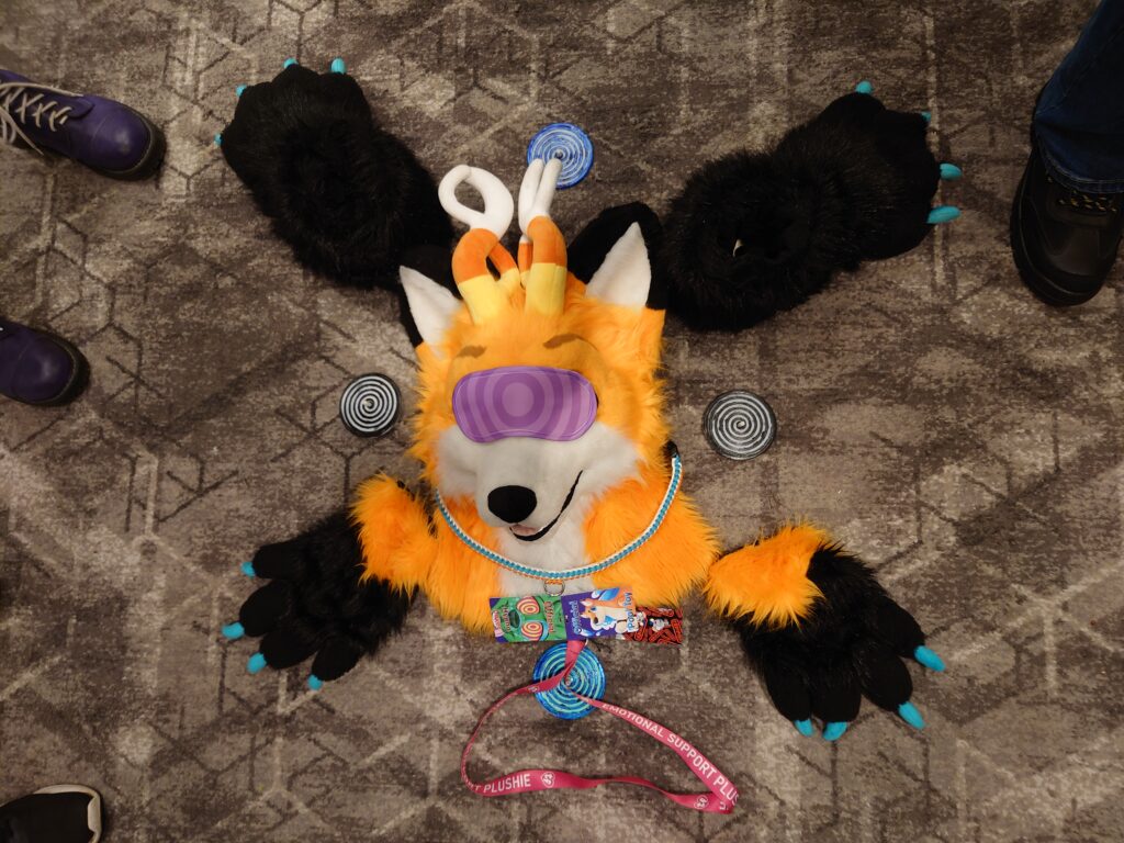 A photo of Jakey's fursuit assembled on the floor with spirals and an eye mask